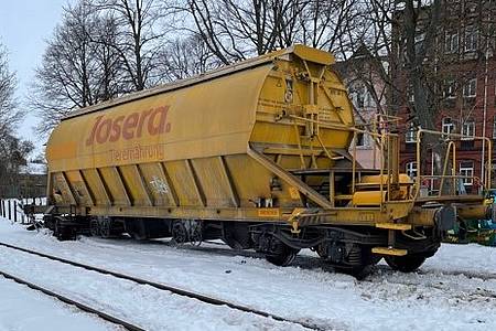 Ein entgleister Güterwaggon steht im Schnee